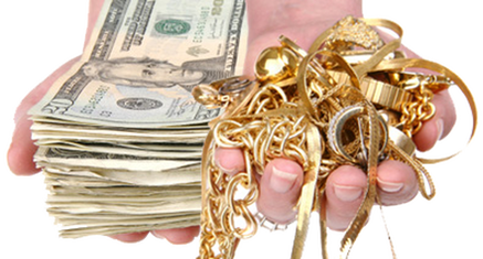 Hand holding $20 bills and jewelry
